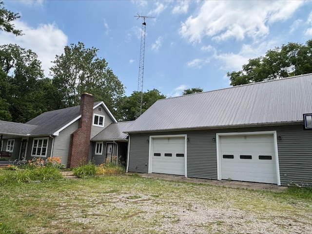 135 S Steer St, Addison, MI 49220 - view of front of home featuring a chimney and a metal roof
