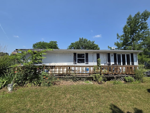 106 Orourke Ct, Brooklyn, MI 49230 - ranch-style house featuring a front lawn and a wooden deck