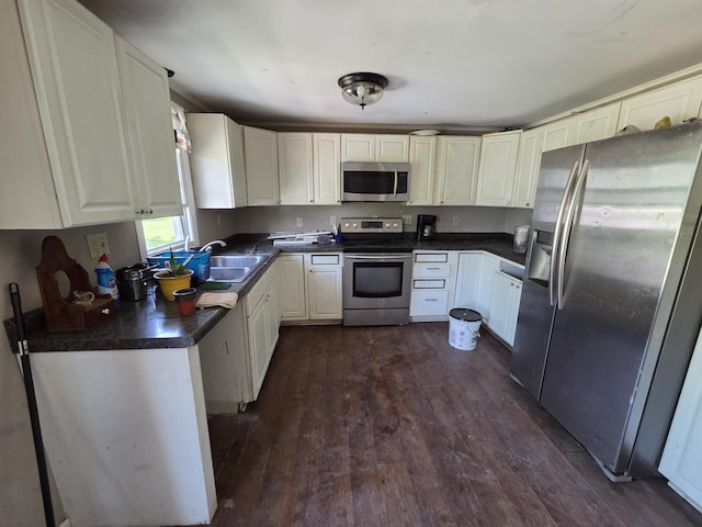106 Orourke Ct, Brooklyn, MI 49230 - kitchen with appliances with stainless steel finishes, dark countertops, dark wood-style flooring, and white cabinets