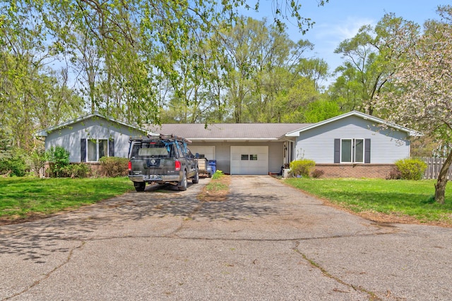 287-289 S Waverly Rd, Holland, MI 49423 - single story home featuring a garage, asphalt driveway, a front lawn, and brick siding