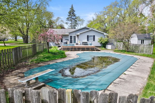 287-289 S Waverly Rd, Holland, MI 49423 - view of pool featuring a wooden deck, a fenced backyard, a storage shed, and a diving board