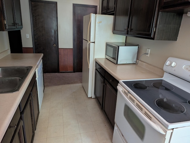 287-289 S Waverly Rd, Holland, MI 49423 - kitchen with white range with electric stovetop, stainless steel microwave, light countertops, and light carpet