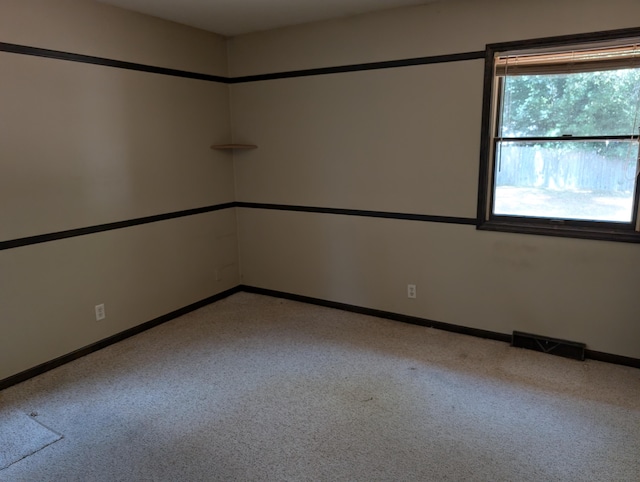 287-289 S Waverly Rd, Holland, MI 49423 - carpeted empty room featuring baseboards