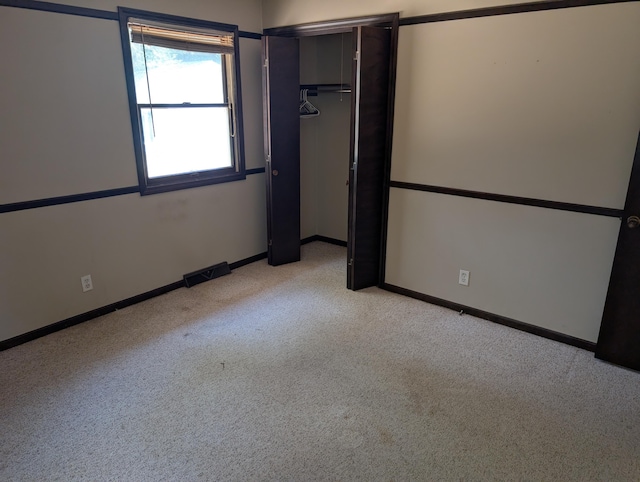 287-289 S Waverly Rd, Holland, MI 49423 - unfurnished bedroom featuring light colored carpet and a closet
