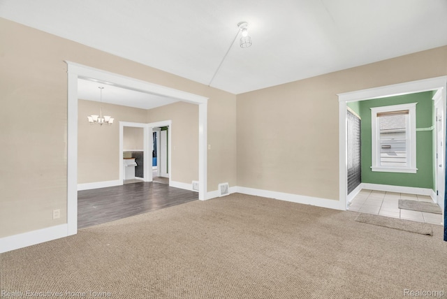 509 13th St, Port Huron, MI 48060 - empty room featuring carpet and a chandelier