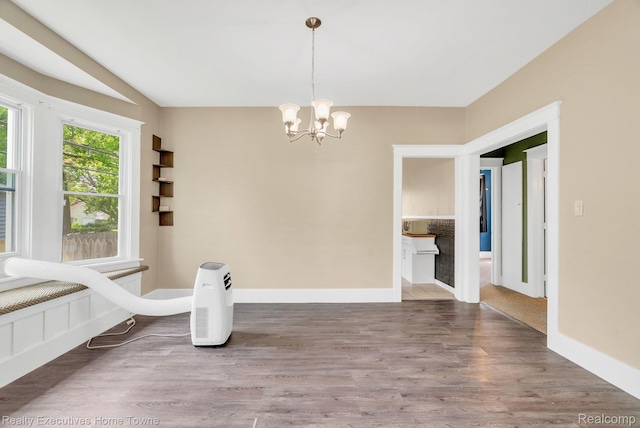 509 13th St, Port Huron, MI 48060 - unfurnished dining area with a chandelier and wood finished floors
