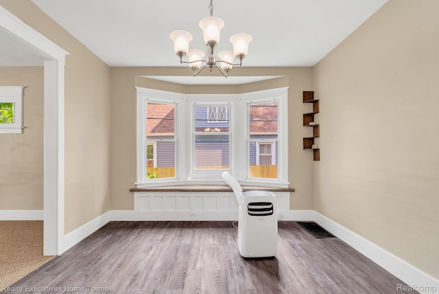 509 13th St, Port Huron, MI 48060 - unfurnished dining area with a chandelier and wood finished floors