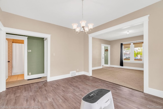 509 13th St, Port Huron, MI 48060 - unfurnished room with a chandelier and wood finished floors