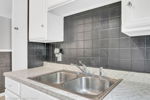 509 13th St, Port Huron, MI 48060 - kitchen with white cabinets, tasteful backsplash, and light stone counters