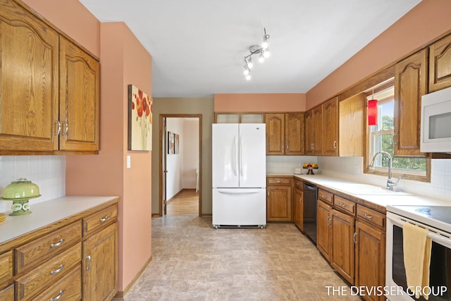 817 Central Ave, Holland, MI 49423 - kitchen featuring white appliances, brown cabinetry, light countertops, and decorative backsplash
