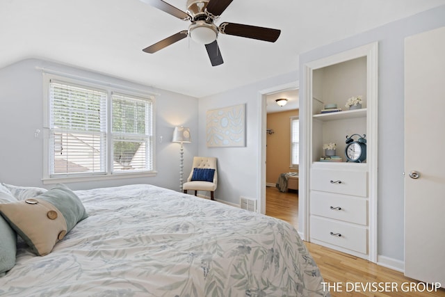 817 Central Ave, Holland, MI 49423 - bedroom featuring light wood finished floors, multiple windows, lofted ceiling, and a ceiling fan