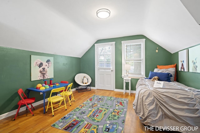 817 Central Ave, Holland, MI 49423 - bedroom featuring wood finished floors and vaulted ceiling