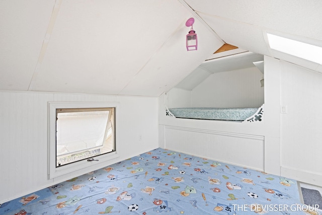 817 Central Ave, Holland, MI 49423 - additional living space with vaulted ceiling, carpet flooring, and a decorative wall