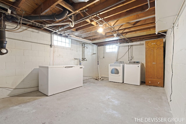 817 Central Ave, Holland, MI 49423 - below grade area featuring independent washer and dryer, white fridge, and plenty of natural light
