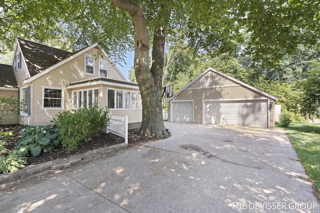 817 Central Ave, Holland, MI 49423 - view of front facade featuring a detached garage and an outbuilding