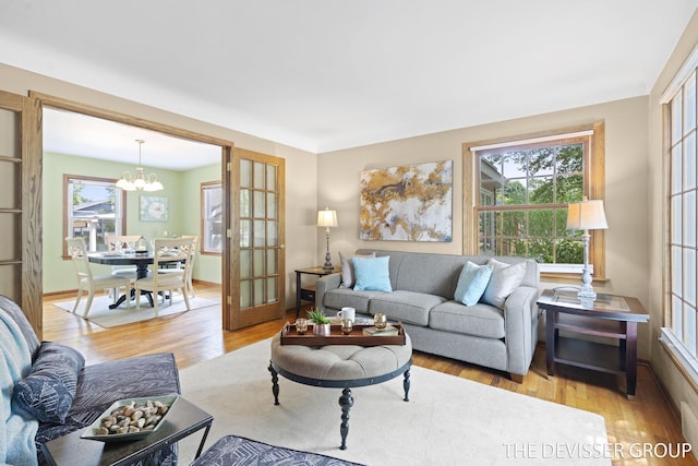 817 Central Ave, Holland, MI 49423 - living room with a chandelier, healthy amount of natural light, and light wood-style floors