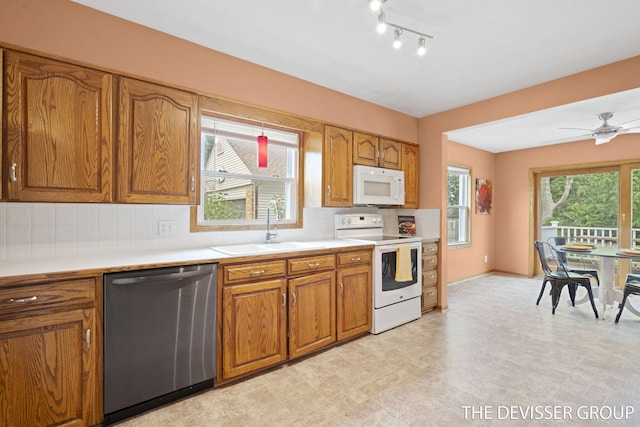817 Central Ave, Holland, MI 49423 - kitchen with white appliances, brown cabinets, light countertops, backsplash, and a ceiling fan