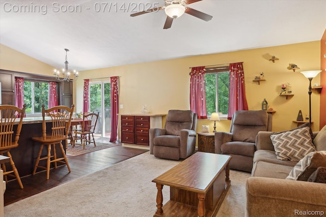 9481 Common Trl, Pinckney, MI 48169 - living room with lofted ceiling, a ceiling fan, a chandelier, and wood finished floors