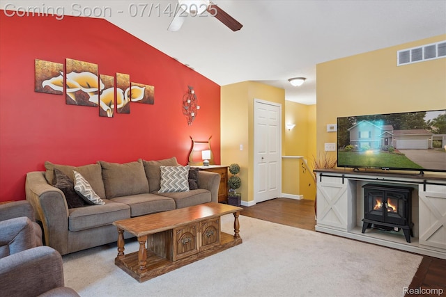 9481 Common Trl, Pinckney, MI 48169 - living room featuring a wood stove, ceiling fan, wood finished floors, and lofted ceiling