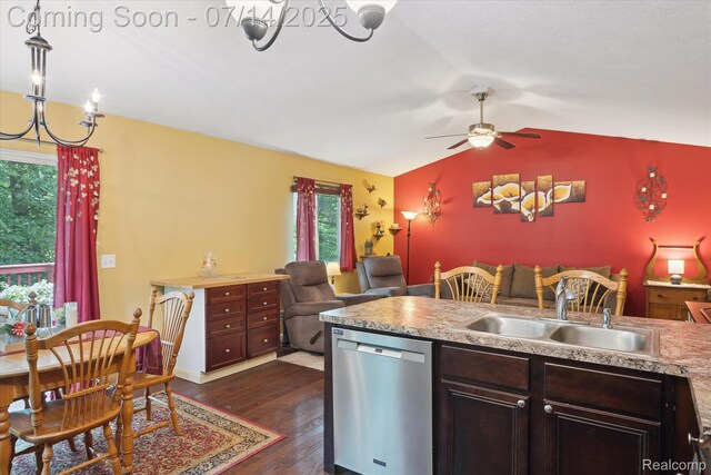 9481 Common Trl, Pinckney, MI 48169 - kitchen with stainless steel dishwasher, a chandelier, vaulted ceiling, dark wood-style flooring, and open floor plan