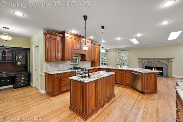 748 Waddington St, Bloomfield Hills, MI 48301 - kitchen with appliances with stainless steel finishes, a peninsula, brown cabinetry, light wood-style flooring, and recessed lighting