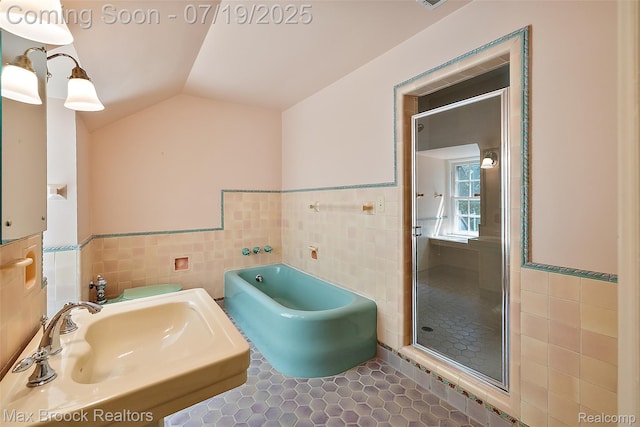 748 Waddington St, Bloomfield Hills, MI 48301 - full bath featuring tile walls, a shower stall, vaulted ceiling, a tub, and tile patterned floors