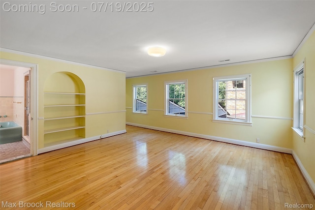 748 Waddington St, Bloomfield Hills, MI 48301 - unfurnished room with wood-type flooring, ornamental molding, and built in shelves