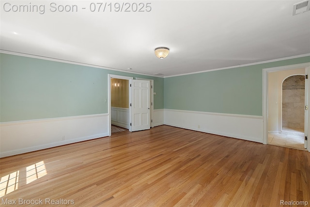 748 Waddington St, Bloomfield Hills, MI 48301 - empty room featuring a wainscoted wall, wood finished floors, and ornamental molding