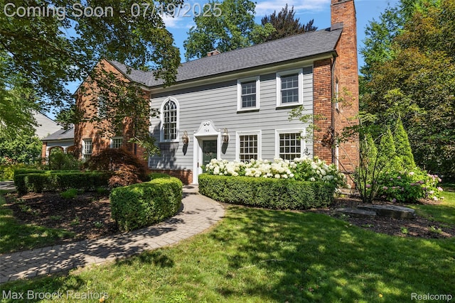 748 Waddington St, Bloomfield Hills, MI 48301 - view of front of home with a chimney, a front yard, and brick siding