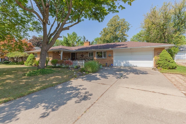 916 Hillcrest Dr, Adrian, MI 49221 - ranch-style home featuring a chimney, brick siding, covered porch, driveway, and a garage