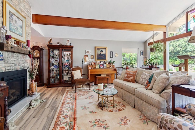 916 Hillcrest Dr, Adrian, MI 49221 - living area with beamed ceiling, wood finished floors, and a stone fireplace