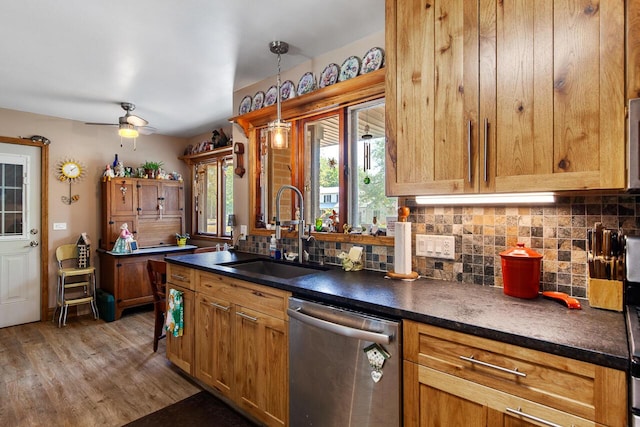 916 Hillcrest Dr, Adrian, MI 49221 - kitchen featuring stainless steel dishwasher, backsplash, dark countertops, wood finished floors, and ceiling fan