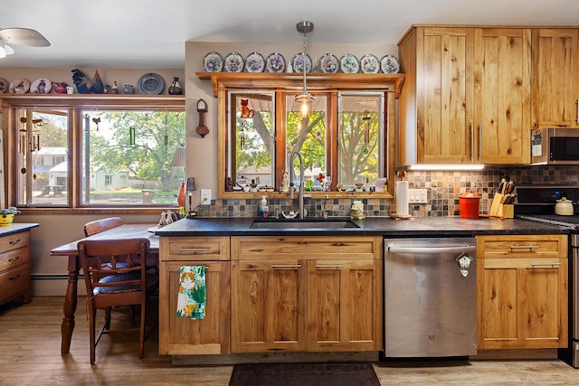 916 Hillcrest Dr, Adrian, MI 49221 - kitchen with appliances with stainless steel finishes, plenty of natural light, backsplash, and dark countertops