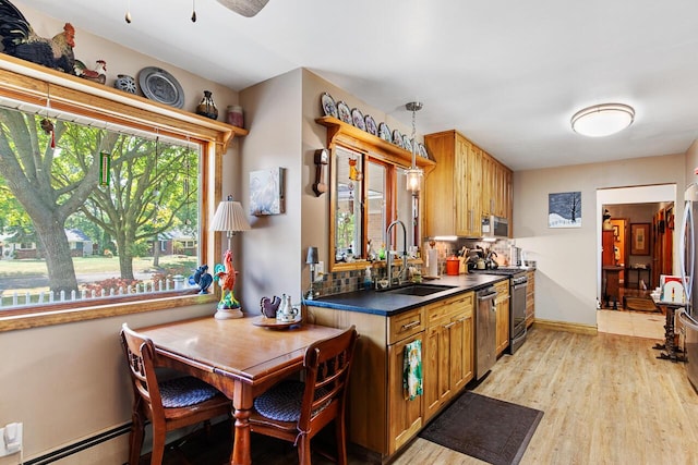 916 Hillcrest Dr, Adrian, MI 49221 - kitchen with stainless steel appliances, dark countertops, decorative backsplash, light wood finished floors, and a ceiling fan