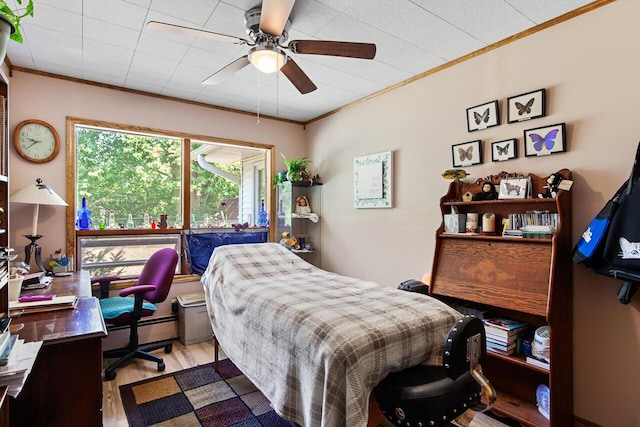 916 Hillcrest Dr, Adrian, MI 49221 - bedroom with wood finished floors, crown molding, a desk, and a ceiling fan