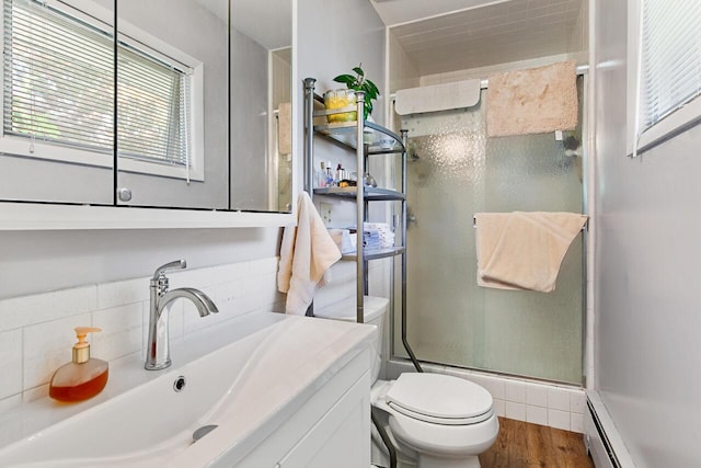 916 Hillcrest Dr, Adrian, MI 49221 - bathroom featuring a stall shower, vanity, a baseboard heating unit, and wood finished floors