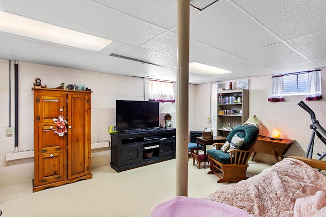 916 Hillcrest Dr, Adrian, MI 49221 - living area with finished concrete floors, a drop ceiling, and concrete block wall
