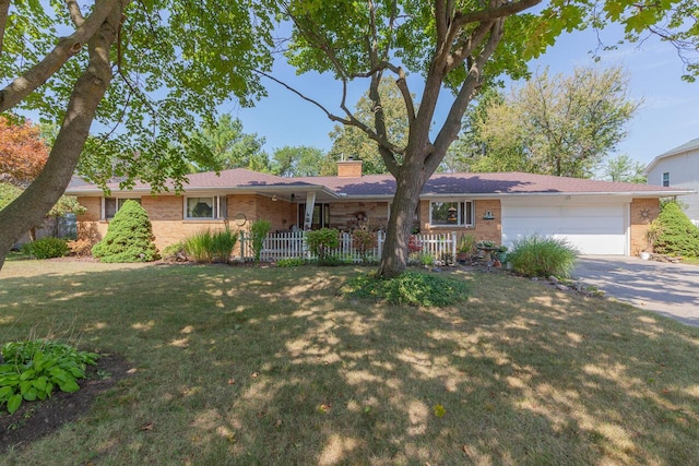 916 Hillcrest Dr, Adrian, MI 49221 - single story home with brick siding, driveway, a chimney, an attached garage, and a front yard