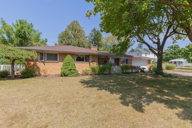 916 Hillcrest Dr, Adrian, MI 49221 - single story home with brick siding, a chimney, and an attached garage