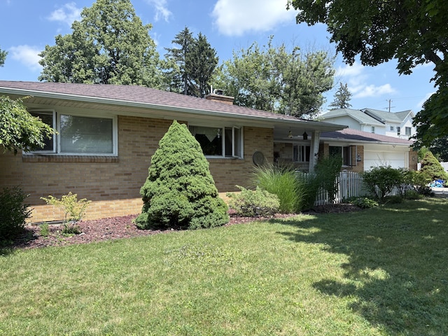 916 Hillcrest Dr, Adrian, MI 49221 - view of front facade with brick siding, a chimney, and an attached garage