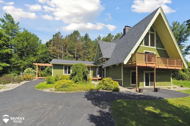 3078 Green Corners Rd, Lapeer, MI 48446 - view of front facade with a chimney, roof with shingles, and a deck