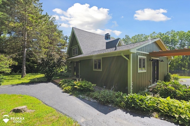 3078 Green Corners Rd, Lapeer, MI 48446 - view of side of property featuring a chimney and roof with shingles