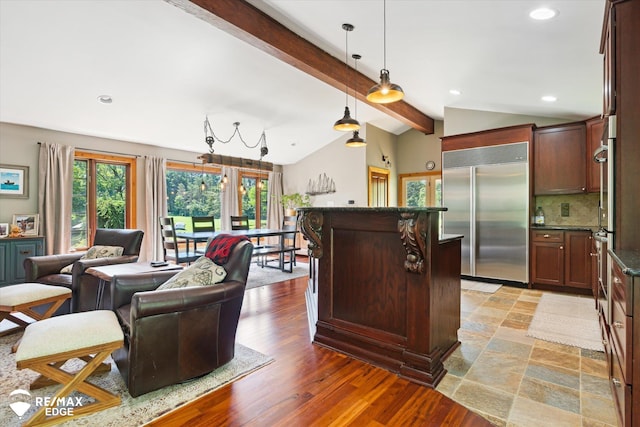 3078 Green Corners Rd, Lapeer, MI 48446 - kitchen featuring built in refrigerator, open floor plan, a center island, hanging light fixtures, and backsplash