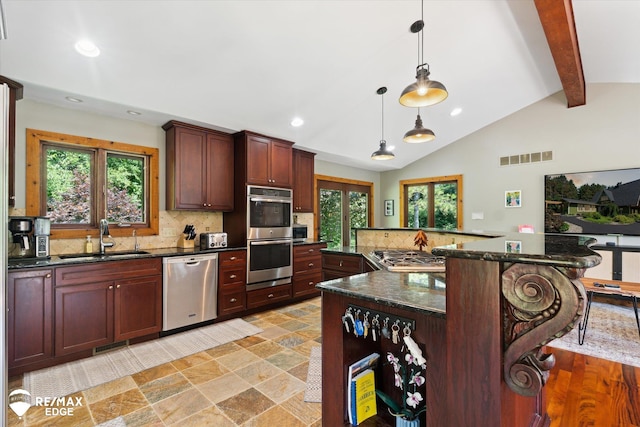 3078 Green Corners Rd, Lapeer, MI 48446 - kitchen featuring appliances with stainless steel finishes, decorative backsplash, a kitchen breakfast bar, recessed lighting, and plenty of natural light