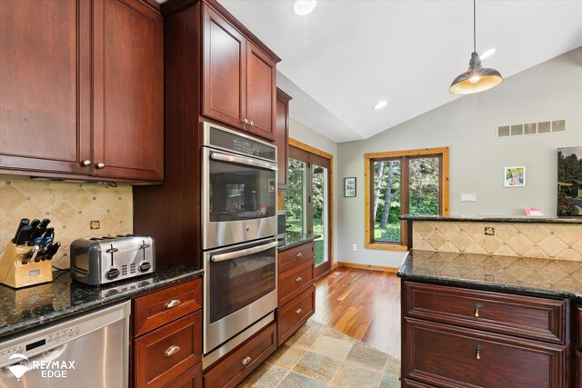 3078 Green Corners Rd, Lapeer, MI 48446 - kitchen with stainless steel appliances, vaulted ceiling, decorative backsplash, recessed lighting, and decorative light fixtures
