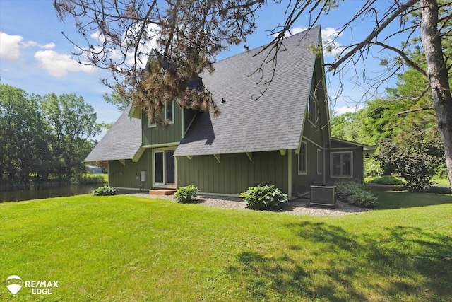 3078 Green Corners Rd, Lapeer, MI 48446 - rear view of house with roof with shingles, a yard, and board and batten siding
