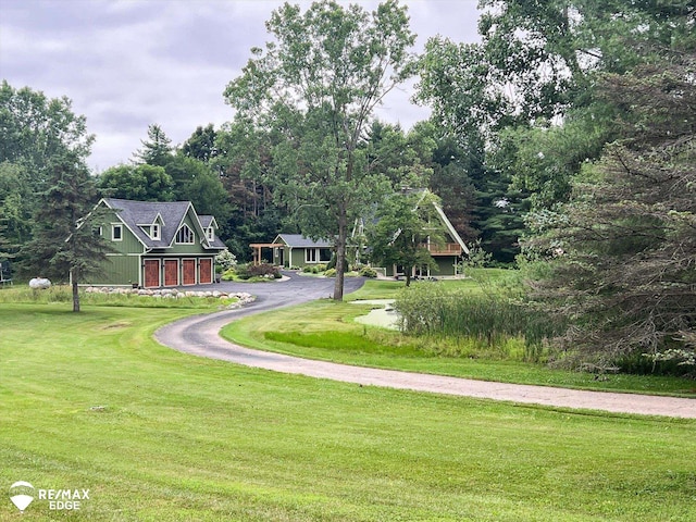3078 Green Corners Rd, Lapeer, MI 48446 - view of community featuring driveway, a lawn, and a garage