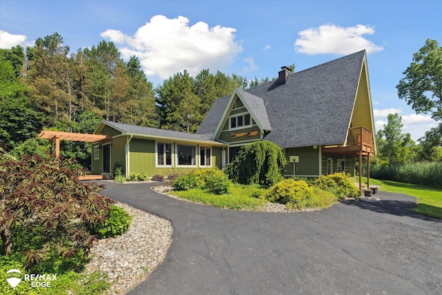 3078 Green Corners Rd, Lapeer, MI 48446 - a-frame style home featuring a chimney, roof with shingles, and asphalt driveway
