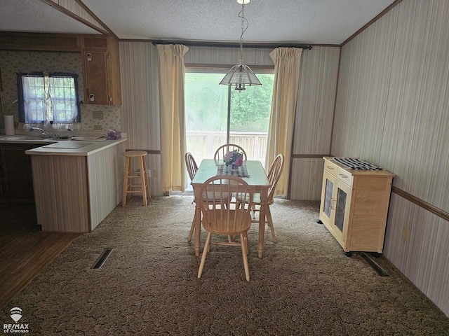 2789 Grass Lake Ave, Clare, MI 48632 - carpeted dining room featuring wallpapered walls and a textured ceiling