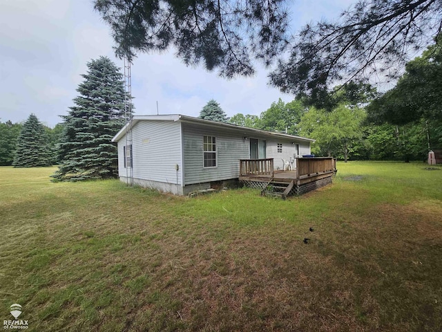2789 Grass Lake Ave, Clare, MI 48632 - rear view of house with a wooden deck and a yard